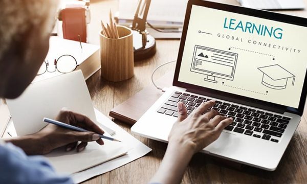 woman on laptop learning for a work at home job