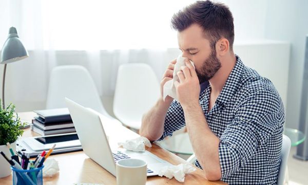 man working from home catching a cold and try to recover