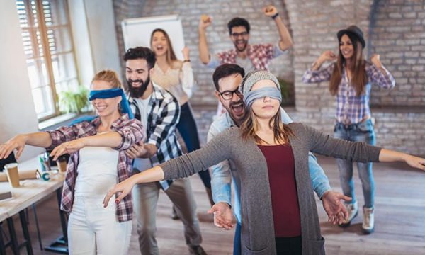 coworkers practicing trust exercises
