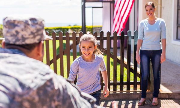work at home mom and her daughter greet military spouse/father back home