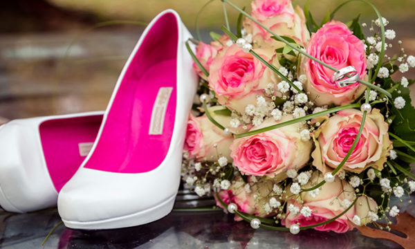 wedding pumps next to flowers