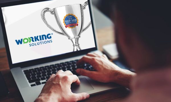 work at home laptop with a trophy and the working solutions logo