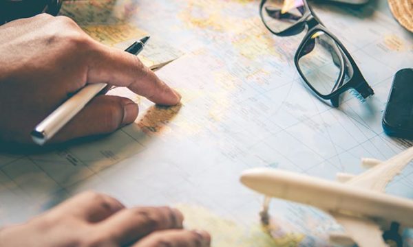 world map hands pointing where to travel