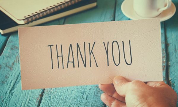 thank you note on a aqua desk background for work at home agent