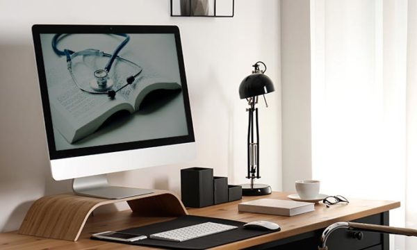 work at home desk with a medical book and medical equipment customer service jobs