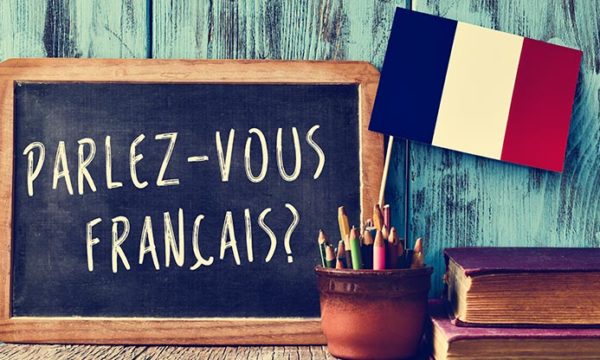 chalk board with the words parle vous francais written on it