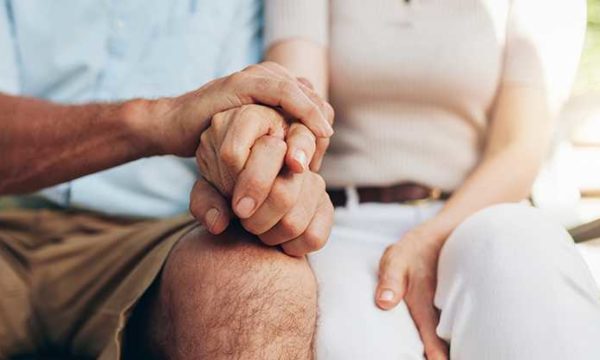 senior couple holding hands senior living customer service agent