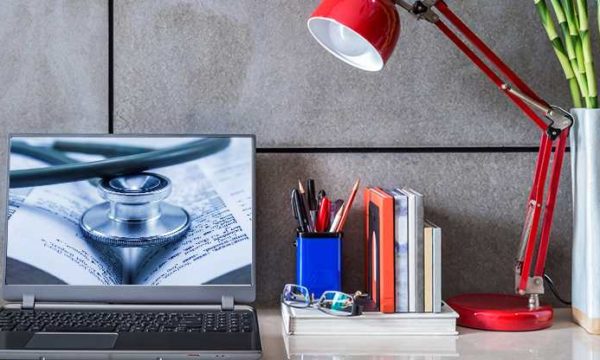 desk with computer with healthcare profile picture for work at home jobs