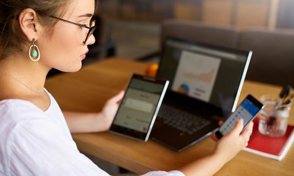 woman working from home being distracted by electronic devices