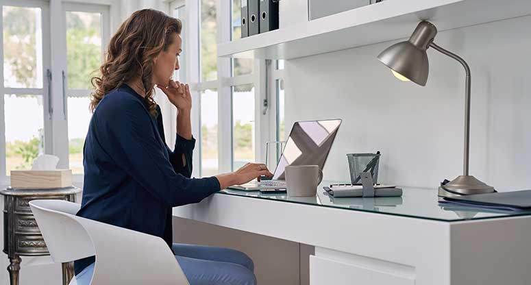 woman on her laptop desk working from home
