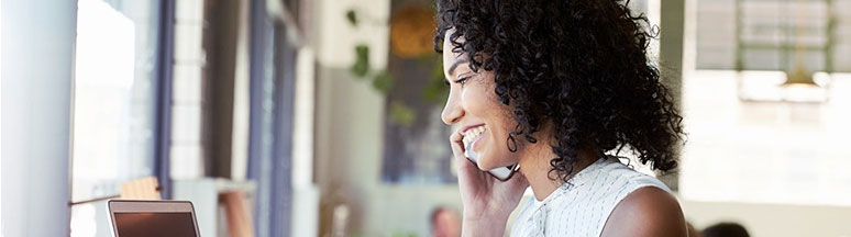 woman getting help from work at home agent looking at computer monitor on her mobile phone
