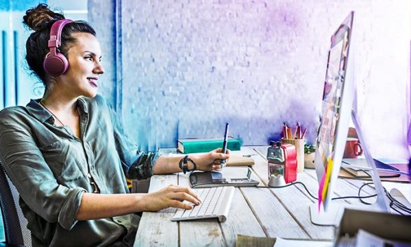 woman working at home and earning money from side hustles