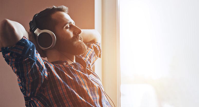 man listening to relaxing music taking a break from work from home shift