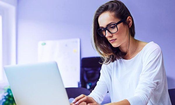 woman working from home using laptop in home office