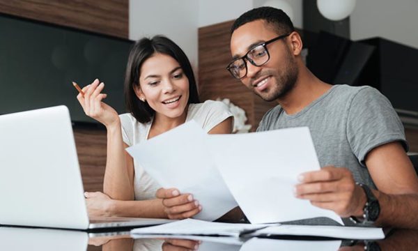 couple working on finances while working from home contractor