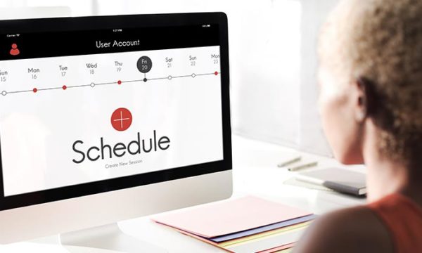 woman working from home looking at computer in time management