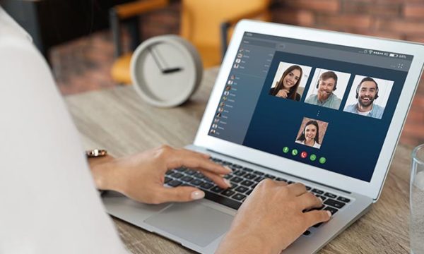 woman collaborating with work at home team via video chat during COVID 19 pandemic