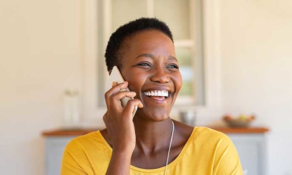 happy woman talking on the phone to work at home customer service agent