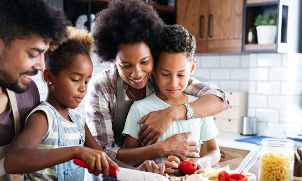 Happy black family cook together in a kitchen