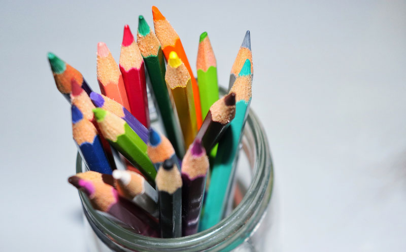 Colored pencils in mason jar, birds eye view , top of pencils