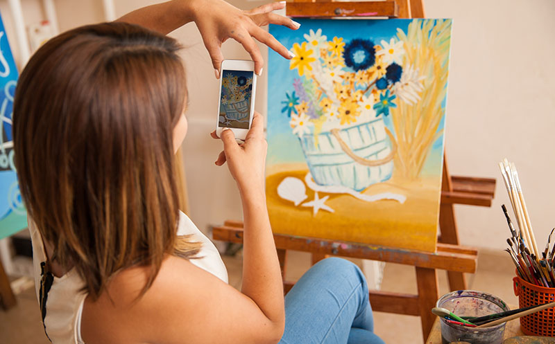 Individual artist takes a photo of her artwork to sell online