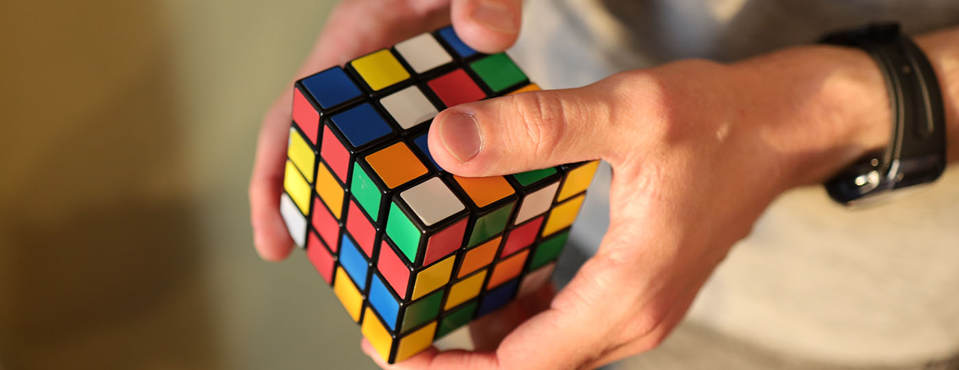 Man's hand holding a Rubik's cube